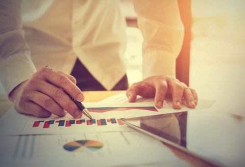 Hand businessman working with documents and tablet at office